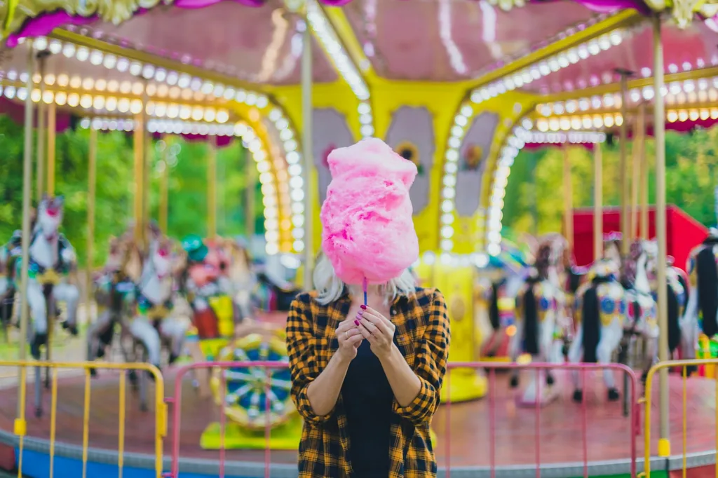 Young woman with cotton candy in her hands