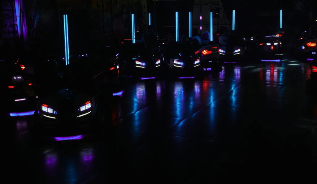 Bumper cars headlights glowing in dark